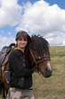 Boy teens and horse at summer day in prairie (series sport, moun Boy teens and horse at summer day in prairie (series sport, moun