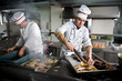 Two chefs at work in a restaurant Two chefs at work in a restaurant