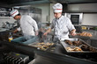 Two chefs at work in a restaurant