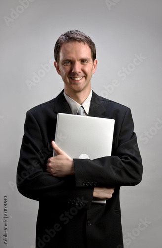 Photo: Man holding laptop Man holding laptop