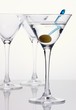 Martini with olive and empty glasses