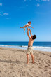 Photo: Father plays with his daughter on the summer beach Father plays with his daughter on the summer beach