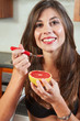 Sexy brunette eating breakfast