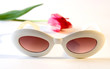 white plastic sunglasses and tulip