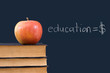 education = $ written on blackboard with apple, books