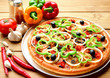 Pizza on metal dish and vegetable