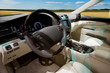 Interior of the luxury car with blurred sky on background