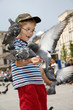 Boy is feeding the birds