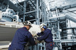industrial workers inside oil refinery