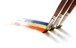 Brushes painting rainbow on white