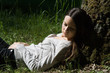 The girl laying near a tree The girl laying near a tree