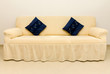 Beige couch and blue cushions. Beige couch and blue cushions.