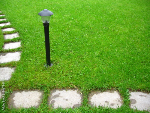 Lantern in the middle of  green lawn