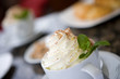 Cup of creamy hot chocolate, close-up, focus on foreground