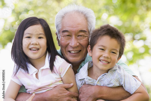 Photo: Grandfather posing with grandchildren Grandfather posing with grandchildren