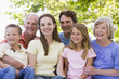 Extended family sitting outdoors smiling