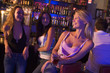 Three young women enjoying drinks together at a nightclub