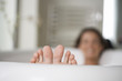 A young woman in the bath, closs-up of feet