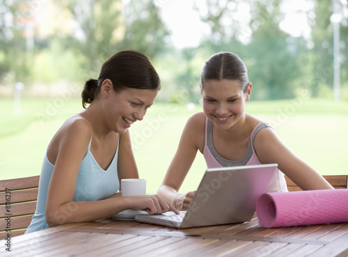 Photo: Two young with a laptop after a yoga class Two young with a laptop after a yoga class