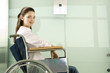 A woman in a wheelchair waiting for the lift