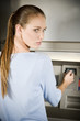 Portrait of a young woman using an ATM cash machine