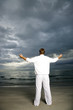 A man standing on a stormy beach