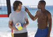 Two men playing beach volleyball