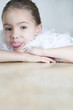 Photo: Portrait of a young girl with a feather boa in dressing up clothes poking her tongue out Portrait of a young girl with a feather boa in dressing up clothes poking her tongue out