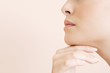 Detail of young woman's face, hand held under her chin