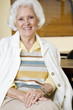 An elderly woman sitting in a chair