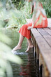 Young woman sitting by a river