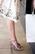 Woman wearing a skirt and high heels, close up of legs