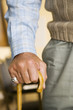 An elderly man holding a walking stick