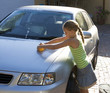 Young girl washing a car