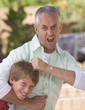 A father with his young son fooling about