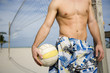 A young man playing beach volleyball
