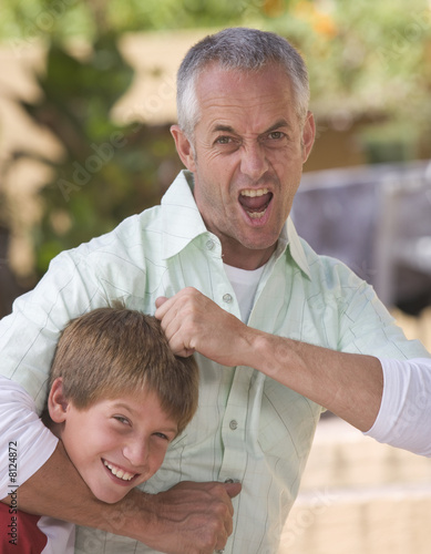 Photo: A father with his young son fooling about A father with his young son fooling about