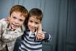 two boys with arms around each other's shoulders