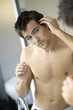 Young man styling his hair