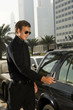 A wealthy man locking his car