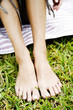 woman's bare feet on the grass
