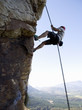 A climber climbing a rock face