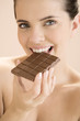 Woman eating a bar of chocolate