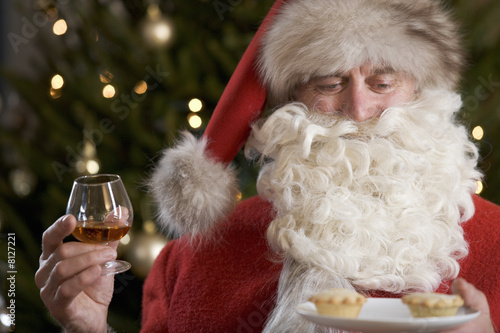 Photo: Father Christmas/Santa Claus eating mince pies with a glass of brandy Father Christmas/Santa Claus eating mince pies with a glass of brandy