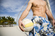 A young man playing beach volleyball