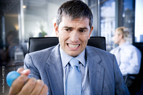 Photo: Businessman squeezing a stress toy Businessman squeezing a stress toy
