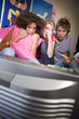 Photo: Three teenage friends (15-17) watching television with scared expressions on faces, television in foreground Three teenage friends (15-17) watching television with scared expressions on faces, television in foreground