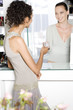 Woman handing credit card to the sales assistant in a store