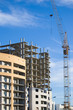 Tower crame working on building construction in a sunny day Tower crame working on building construction in a sunny day