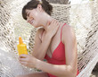 A woman applying sun lotion